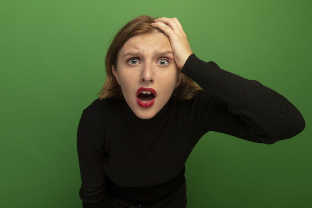 The current image has no alternative text. The file name is: concerned-young-blonde-woman-putting-hand-head-looking-front-isolated-green-wall-scaled.jpg